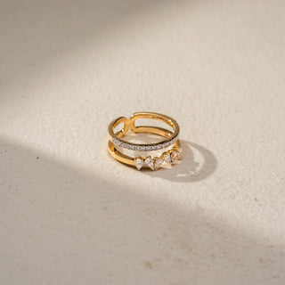 Top view of a floral diamond ring in 14 KT Yellow Gold, featuring a cluster of round lab-grown diamonds nestled within an eye-shaped openwork motif and accented by marquise-cut side diamonds, displayed against a beige backdrop.