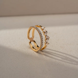 Angled view of a floral diamond ring in 14 KT Yellow Gold, featuring a cluster of round lab-grown diamonds nestled within an eye-shaped openwork motif and accented by marquise-cut side diamonds, displayed against a beige backdrop.