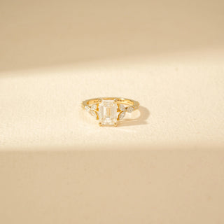 Close-up view of Emerald-Cut Diamond Ring in 14KT Yellow Gold, featuring an emerald-cut centre diamond and marquise side diamonds.