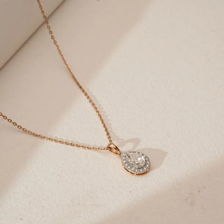 Top angled view of Classic Pear Halo Diamond Pendant in 18KT Rose Gold, featuring a pear-cut centre diamond surrounded by a sparkling halo, suspended on a delicate rose gold chain.