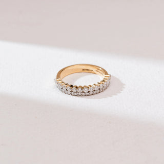 Angled front view of the Double Row Shimmering Diamond Ring in 14KT yellow gold, showcasing two parallel rows of round brilliant diamonds—one larger and one pavé-set—on a polished band against a neutral background.