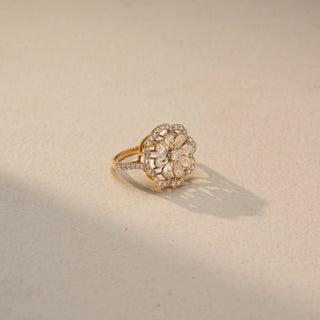 Angled front view of a floral diamond statement ring in 14 KT Yellow Gold, featuring marquise-shaped lab-grown diamonds arranged in an intricate flower motif with pavé diamond accents, displayed against a beige backdrop