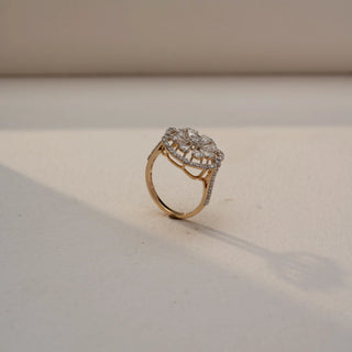 Side view of a floral diamond statement ring in 14 KT Yellow Gold, featuring marquise-shaped lab-grown diamonds arranged in an elevated flower motif with pavé diamond accents, displayed against a beige backdrop.