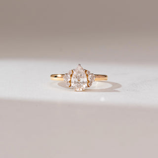 Front view of Modern Antique Inspired Diamond Ring, 14KT yellow gold band featuring a pear-shaped centre diamond with round diamond cluster side accents.