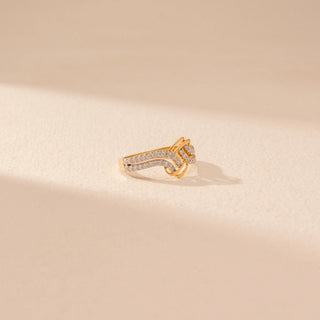 Side view of a 14KT yellow gold ring featuring round-cut diamonds in an interlocking wave design, set against a beige background.