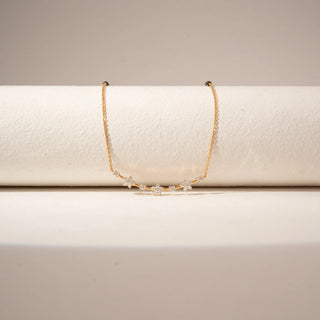 Close-up view of a 14KT Yellow Gold diamond mangalsutra featuring a curved bar with round-shaped diamond clusters and delicate chain detailing.