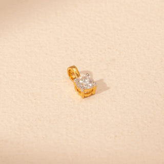 Angled view of Solitaire Diamond Pendant in 14KT Yellow Gold, featuring a round lab-grown diamond in a four-prong setting.