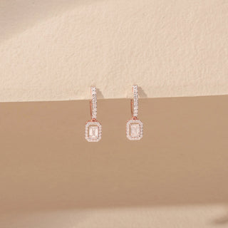 Front view of Emerald-Cut Diamond Drop Earrings in 14KT Rose Gold, featuring rectangular emerald-cut diamonds with pavé halos.