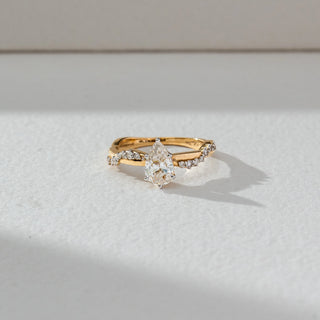 Top view of Marquise Solitaire Diamond Ring in 14KT Yellow Gold, featuring a centred marquise lab grown diamond with pavé accents. Set on a neutral backdrop, the design highlights symmetry and refined brilliance.
