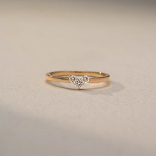 Front view of a Trio Diamond Chevron Ring in 14KT Yellow Gold, featuring three round lab-grown diamonds in a V-shaped setting. Shot against a beige backdrop, highlighting delicate sparkle and minimalist elegance.