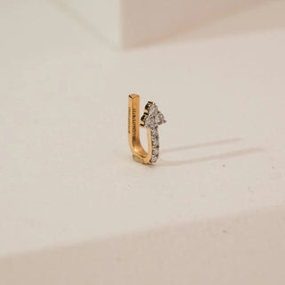 Side angle view of yellow gold diamond nosepin featuring a clover-shaped cluster of round lab-grown diamonds with a slim pavé-set diamond line, displayed on a neutral studio background.
