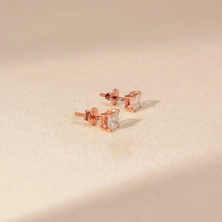 Side view of Square Diamond Stud Earrings in 14KT Rose Gold, featuring matching square-cut diamonds in four-prong settings.