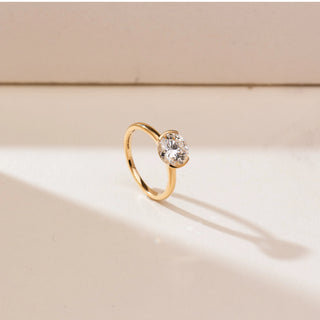 Side angle view of 14KT yellow gold ring featuring a round brilliant-cut centre diamond in a sleek bezel-style setting on a polished minimalist band.