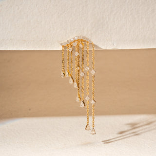 Close-up view of 14KT Yellow Gold diamond fringe earrings featuring curved pavé-set tops and cascading diamond chains.