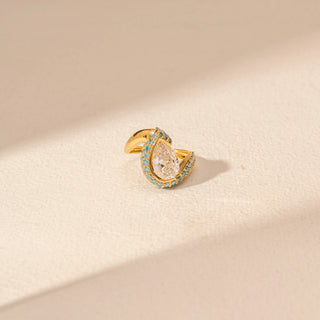 Close-up view of Pear-Cut Diamond Ring in 14KT Yellow Gold, featuring a pear-shaped centre diamond with blue gemstone accents.