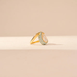 Side view of Pear-Cut Diamond Ring in 14KT Yellow Gold, featuring a pear-shaped centre diamond with blue gemstone accents.