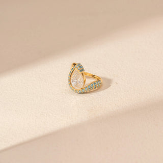 Top view of Pear-Cut Diamond Ring in 14KT Yellow Gold, featuring a pear-shaped centre diamond with blue gemstone accents.