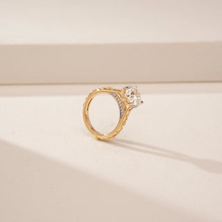 Side view of a 14KT Yellow Gold diamond ring, featuring a round centre diamond and diamond-set inner band.