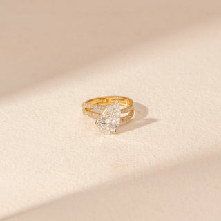 Top view of Pear-Shaped Solitaire Diamond Ring in 14KT Yellow Gold, featuring a pear-cut lab-grown diamond and pavé bands.