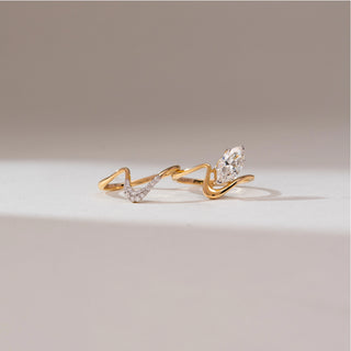 Side profile view of 14KT yellow gold wave ring featuring a marquise-cut centre diamond and a flowing multi-band design with pavé-set diamond accents along one curve.