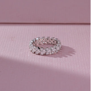 Top view of Multi Shape Diamond Band Ring in 14KT White Gold, featuring mixed round and fancy-cut lab grown diamonds in clustered settings. Set on a pink backdrop, the design highlights symmetry and bold sparkle.
