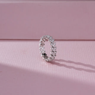Side view of Multi Shape Diamond Band Ring in 14KT White Gold, featuring mixed round and fancy-cut lab grown diamonds in clustered settings. Set on a pink backdrop, the design highlights structure and brilliance.
