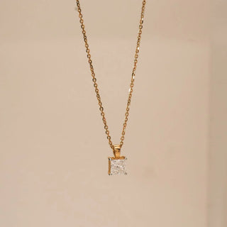 Front view of yellow gold pendant showcasing a radiant-cut lab grown diamond solitaire in a classic four-prong setting, suspended on a fine chain against a soft neutral background.