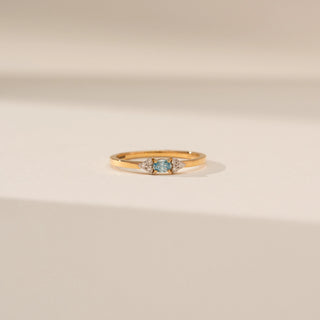 Front view of Blue Diamond Ring in 14KT Yellow Gold, featuring a round blue diamond and round lab-grown diamond side stones.