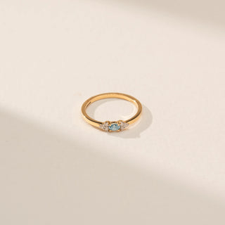 Top view of Blue Diamond Ring in 14KT Yellow Gold, featuring a round blue diamond with round lab-grown diamond side stones.