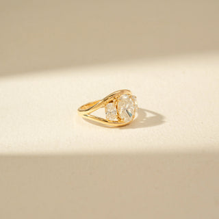 Side view of Three-Stone Oval Diamond Ring in 14KT Yellow Gold, featuring an oval centre diamond and two side stones.