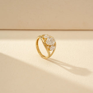 Angled view of Three-Stone Oval Diamond Ring in 14KT Yellow Gold, featuring an oval centre diamond and two side stones.