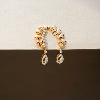 Side view of diamond ear climber earrings in 14 KT Yellow Gold, featuring pear-shaped diamonds in a curved arrangement with dangling pear halo drops against a neutral backdrop.
