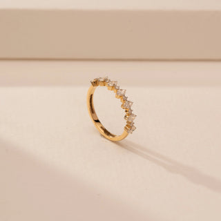 Angled view of a 14KT Yellow Gold diamond ring, featuring alternating marquise and round diamonds along the band.