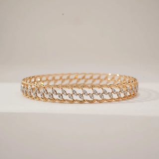 Front view of yellow gold diamond bangle featuring marquise leaf-style links formed with round lab-grown diamond clusters, creating a continuous elegant pattern on a neutral display surface.