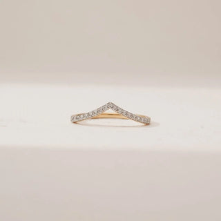 Front view of Elegant Gold Chevron Diamond Band in yellow gold, featuring round lab-grown diamonds set along a delicate V-shaped chevron design, displayed on a soft neutral surface.