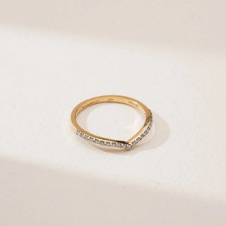 Top angled view of Elegant Gold Chevron Diamond Band in yellow gold, featuring round lab-grown diamonds set along a slender V-shaped chevron design, displayed on a neutral surface.