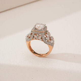 Side angled view of Ornate Vintage Halo Diamond Ring in rose gold, showcasing a raised round lab-grown centre diamond with square halo and intricate marquise and pavé diamond detailing.