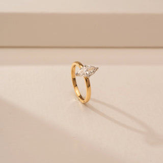 Angled view of a 14KT Yellow Gold diamond ring with two marquise-shaped diamonds arranged vertically in a four-prong setting.