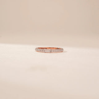 Front view of a 14KT Rose Gold diamond ring, featuring a rectangular emerald-cut diamond and diamond-set band.