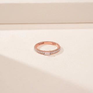 Top view of a 14KT Rose Gold diamond ring, featuring a rectangular emerald-cut diamond and diamond-set band.