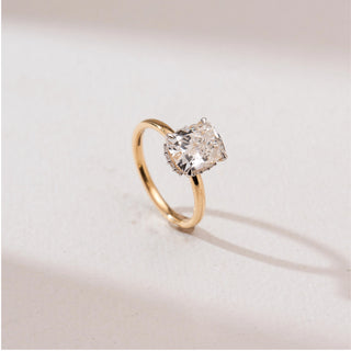 Angled view of Modern Elongated Cushion Diamond Ring in 14KT yellow gold, showcasing a large elongated cushion-cut centre diamond in a hidden halo basket on a sleek band.