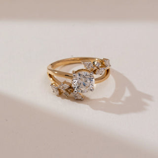 Top view of Floral Cluster Round Diamond Ring in 14KT yellow gold, featuring a round centre diamond with marquise-shaped floral cluster accents on a polished split-style band.