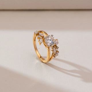 Side profile view of Floral Cluster Round Diamond Ring in 14KT yellow gold, showcasing a raised round centre diamond with marquise-shaped cluster accents on a polished band.