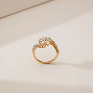 Side view of Pear Petal Cluster Diamond Ring in yellow gold, highlighting pear-shaped lab-grown diamonds forming a raised floral cluster with a diamond-studded bypass band on a neutral background.