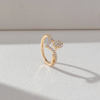 Side view of Pear Cluster Diamond Ring in 14KT Yellow Gold, featuring round lab grown diamonds in a pear-shaped cluster with a pavé chevron band. Set on a beige backdrop, the design highlights structure and sparkle.
