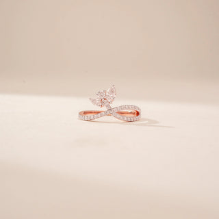 Front view of a 14KT Rose Gold diamond ring with a butterfly motif and pavé-set crossover band.