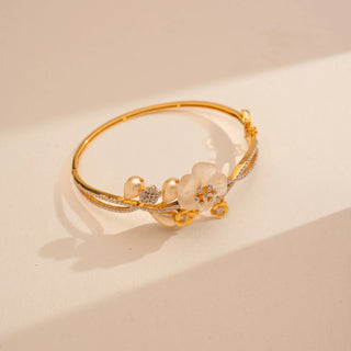 Angled view of Reia’s 14 KT Yellow Gold Ornate Pearl Floral Diamond Bracelet. The layout highlights the architectural multi-layered floral motif and the warm glow of the gold.