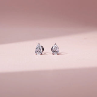Front view of pear-shaped lab-grown diamond stud earrings in 14 KT rose gold, featuring three-prong pear-cut solitaire diamonds with open basket settings in a timeless elegant design.