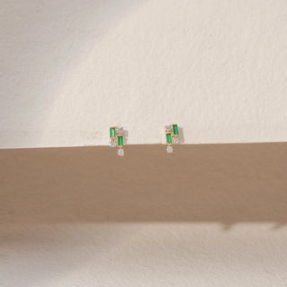 Front view of Emerald Diamond Earrings in 14KT Yellow Gold, featuring baguette-cut green gemstones and round lab-grown diamonds.