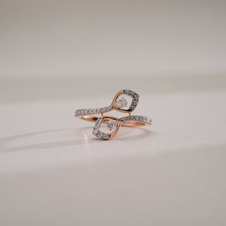 Infinity Embrace Diamond Promise Ring in 14KT Rose Gold with twin pear-shaped lab-grown diamonds and a shimmering band, symbolising love and unity, displayed on a neutral surface.